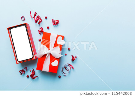 Opened gift box with ribbon and phone on color background, top view. Blank open box packaging mockup , Template for your design - branding mockup Opened gift box with ribbon and phone on color background, top view. Blank open box packaging mockup , Template for your design - branding mockup 115442008