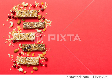 Various granola bars on table background. Cereal granola bars. Superfood breakfast bars with oats, nuts and berries, close up. Superfood concept Various granola bars on table background. Cereal granola bars. Superfood breakfast bars with oats, nuts and berries, close up. Superfood concept 115442030