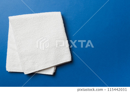 Top view of white towels with copy space on colored background Top view of white towels with copy space on colored background 115442031