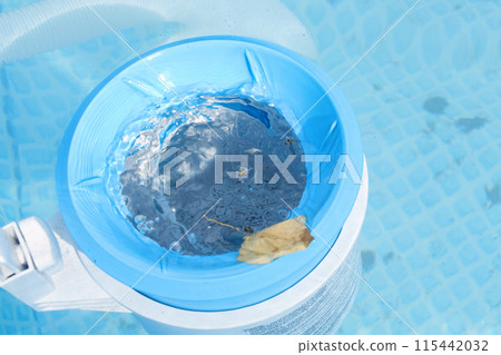 Top view of the blue skimmer for cleaning the pool in clear water. Contaminated pool cleaning concept Top view of the blue skimmer for cleaning the pool in clear water. Contaminated pool cleaning concept 115442032