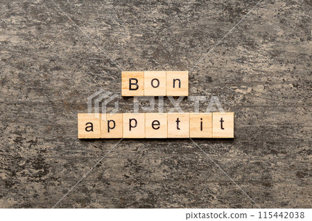 Bon Appetit word written on wood block. Bon Appetit text on cement table for your desing, concept 115442038