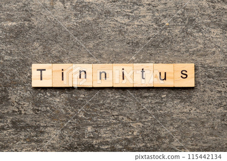 TINNITUS word written on wood block. TINNITUS text on cement table for your desing, concept TINNITUS word written on wood block. TINNITUS text on cement table for your desing, concept 115442134
