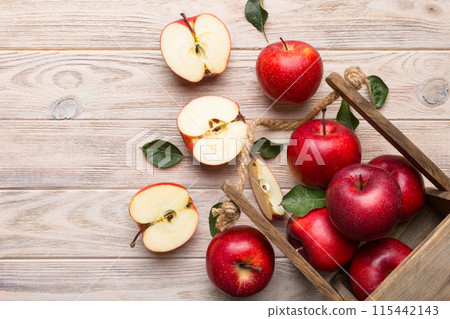 Ripe red apples in wooden box. On a white wooden background 115442143