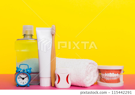 Mouthwash and other oral hygiene products on colored table top view with copy space. Flat lay. Dental hygiene. Oral care kit. Dentist concept 115442291