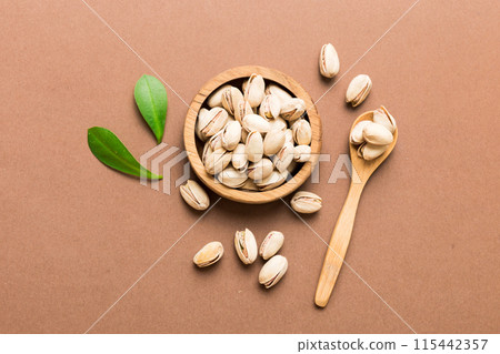 Fresh healthy Pistachios in bowl on colored table background. Top view Healthy eating concept. Super foods 115442357