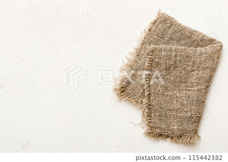 Old burlap fabric napkin, sackcloth on table background. top view with copy space Old burlap fabric napkin, sackcloth on table background. top view with copy space 115442382