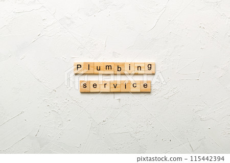 Plumbing service word written on wood block. Plumbing service text on cement table for your desing, concept Plumbing service word written on wood block. Plumbing service text on cement table for your desing, concept 115442394
