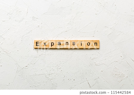 expansion word written on wood block. expansion text on table, concept 115442584