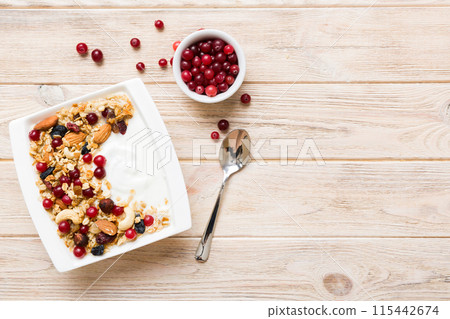 Healthy breakfast food with granola, yogurt, fruits and nuts. Dessert parfait with dried fruits for breakfast 115442674