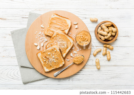 Peanut butter sandwiches or toasts on light table background.Breakfast. Vegetarian food. American cuisine top view vith copy space 115442683