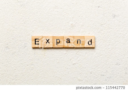 EXPAND word written on wood block. EXPAND text on cement table for your desing, concept EXPAND word written on wood block. EXPAND text on cement table for your desing, concept 115442770