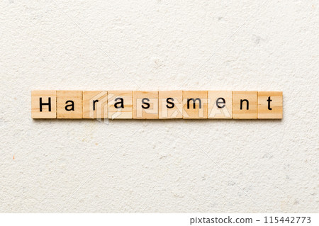 harassment word written on wood block. harassment text on cement table for your desing, concept 115442773