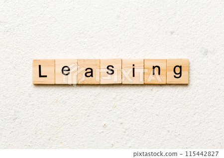 leasing word written on wood block. leasing text on table, concept leasing word written on wood block. leasing text on table, concept 115442827