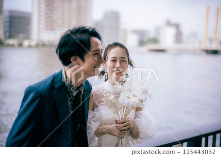 Bride and groom laughing by the river Bride and groom laughing by the river 115443032