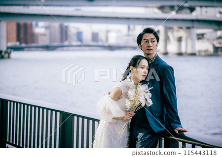 Bride pressing her ear to the groom's chest Bride pressing her ear to the groom's chest 115443118