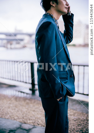 Groom walking along the river 115443644