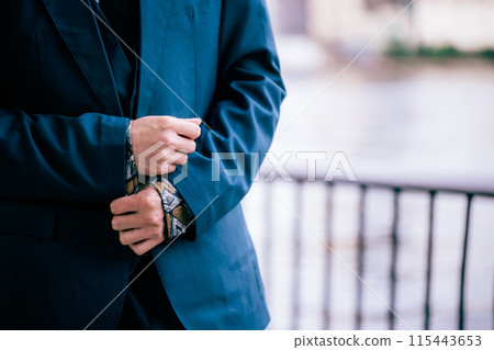 Groom walking along the river 115443653