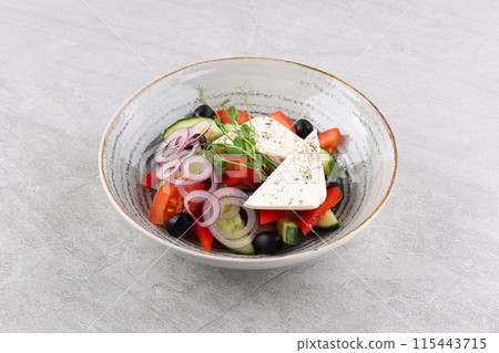 Salad with cheese and fresh vegetables isolated on white background. Greek salad. Salad with cheese and fresh vegetables isolated on white background. Greek salad. 115443715