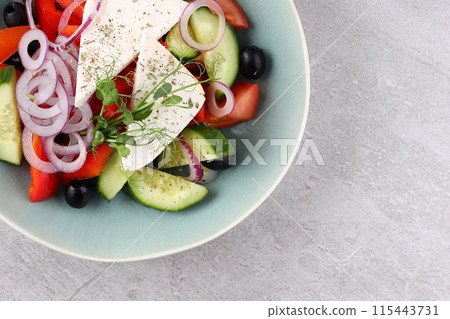 Salad with cheese and fresh vegetables isolated on white background. Greek salad. 115443731
