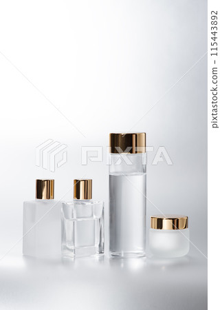 A glass cosmetic container with a gold cap for a luxurious look 115443892