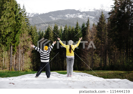 Children celebrating in snowy mountain forest Children celebrating in snowy mountain forest 115444159
