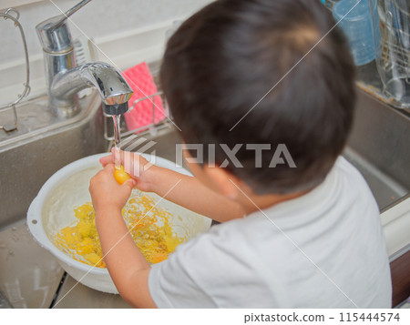 Boy washing plums Boy washing plums 115444574