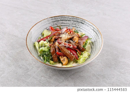 Beef steak salad with cherry tomatoes, cucumbers, red onions, romaine salad and lime mustard olive oil salad dressing 115444583