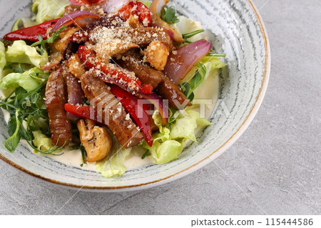 Beef steak salad with cherry tomatoes, cucumbers, red onions, romaine salad and lime mustard olive oil salad dressing Beef steak salad with cherry tomatoes, cucumbers, red onions, romaine salad and lime mustard olive oil salad dressing 115444586
