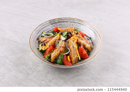Crunchy thai style chicken salad in bowl over light stone background. Close up view 115444940