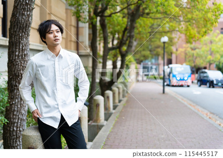 Young business man walking down the street 115445517