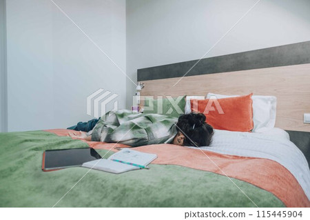 student collapses face-down on a bed, overwhelmed by the demands of study, illustrating the importance of taking breaks to avoid burnout student collapses face-down on a bed, overwhelmed by the demands of study, illustrating the importance of taking breaks to avoid burnout 115445904