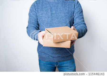 Young anonymus adult with two delivery cardboard boxes Young anonymus adult with two delivery cardboard boxes 115446143
