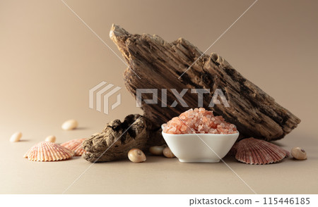 Pink himalayan salt with snags and seashells on a beige background. Pink himalayan salt with snags and seashells on a beige background. 115446185