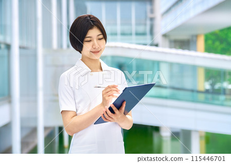 Smiling medical worker in white coat working in hospital 115446701