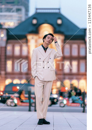 Groom posing in front of Tokyo Station 115447136