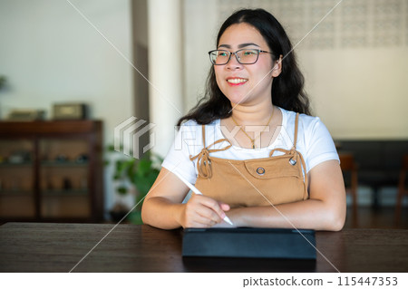 Portrait asian freelance people business female wearing glasses stylish hipste Draw or taking note on digital tablet with electronic pen for browsing internet, chatting and blogging in coffee shop. Portrait asian freelance people business female wearing glasses stylish hipste Draw or taking note on digital tablet with electronic pen for browsing internet, chatting and blogging in coffee shop. 115447353