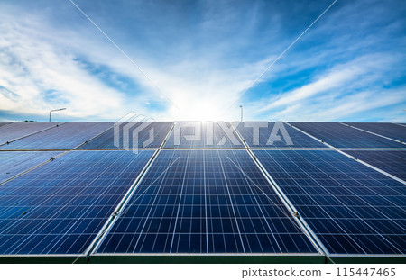 Photovoltaic solar power panel on dramatic sunset blue sky background, green clean Alternative power energy concept. 115447465