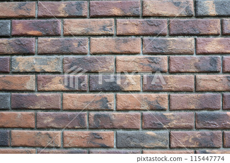 Aged brown and black brick wall Aged brown and black brick wall 115447774