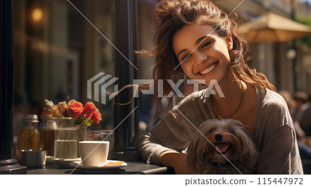 A happy young woman and her fluffy dog are sitting at a table in a cozy street cafe 115447972