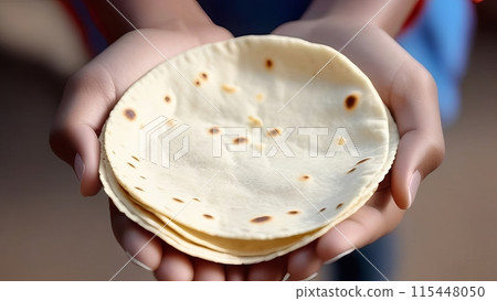 Top view of hands holding a stack of flatbread, close up 115448050