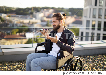 Young man in wheelchair speaking on smartphone outdoor Young man in wheelchair speaking on smartphone outdoor 115448068