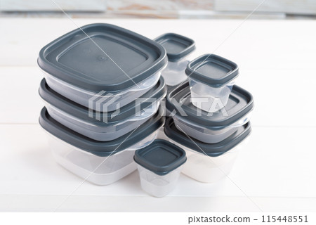 Stack of food plastic containers of different sizes. Storing food for freezing 115448551