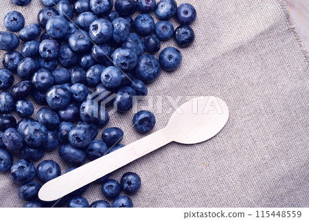 Fresh blueberries scattered on the table Fresh blueberries scattered on the table 115448559