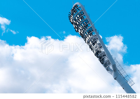 Stadium light with copy space. Stadium floodlights against a clear blue sky 115448582