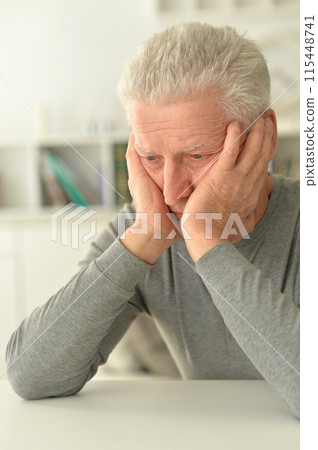 close-up portrait of a senior man thinking about something 115448741