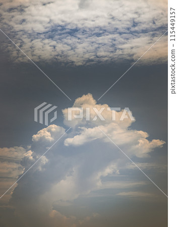 The softness of the white clouds, and sky with the light shining from an interesting light pattern against the sky. 115449157