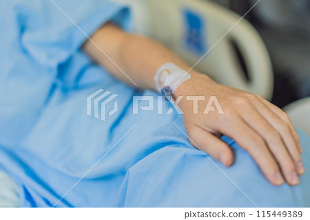 A woman in the hospital has a catheter inserted into her arm for IV drips. The medical procedure is performed to administer fluids, medication, or nutrients directly into her bloodstream, ensuring A woman in the hospital has a catheter inserted into her arm for IV drips. The medical procedure is performed to administer fluids, medication, or nutrients directly into her bloodstream, ensuring 115449389