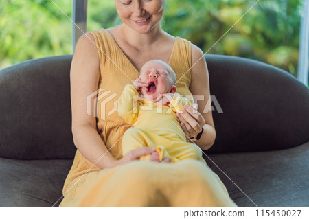 Mom with newborn baby relaxing on the sofa at home. This tender moment highlights the bond between mother and child in a comfortable and loving family environment 115450027