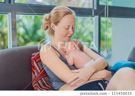 Mom with newborn baby relaxing on the sofa at home. This tender moment highlights the bond between mother and child in a comfortable and loving family environment 115450035