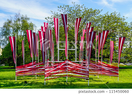 Many national flags of Latvia flutter in the wind, decoration of the city square in holidays 115450060